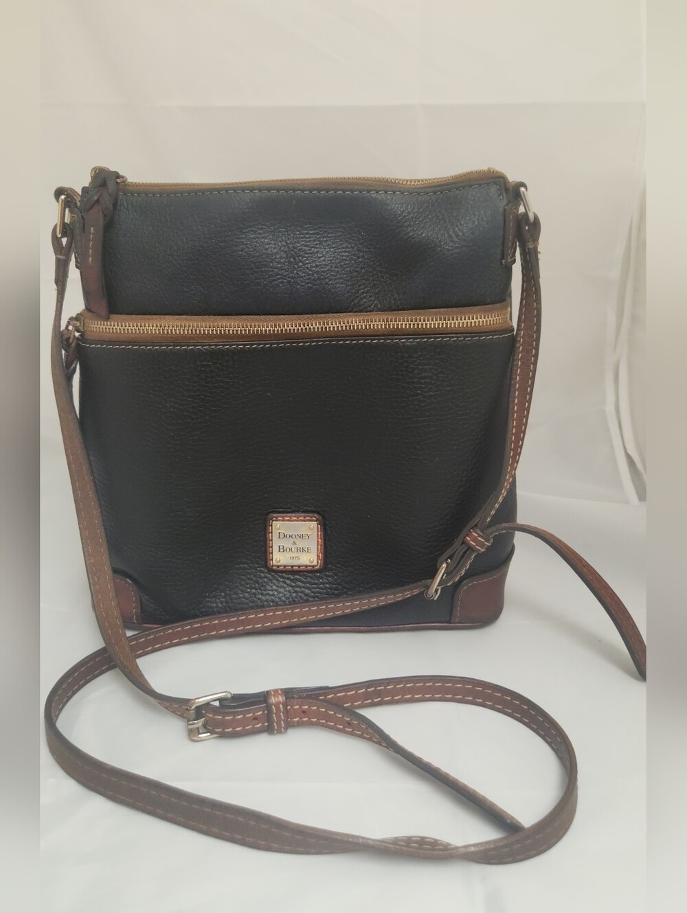 Dooney & Bourke Black Pebbled Leather Crossbody with Brown Trim and Gold Accents